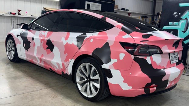 Pink, black, and white camouflage vehicle wrap on a Tesla at 777 Wraps in Amarillo, Texas.